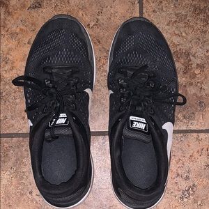 Black Nike light-soled athletic sneakers